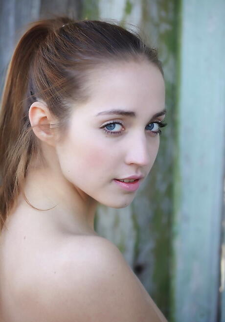 Gracile young Milana G in fancy skirt exhibits small tits and spreads her legs 