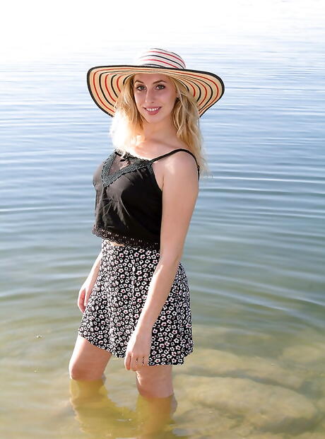 Enticing cutie Camille in sexy skirt exposing big knockers and hot ass on the beach